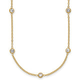 Gold necklace with small bezel set diamonds on a white background