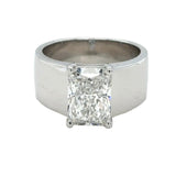 wide white gold cigar band engagement ring with radiant diamond